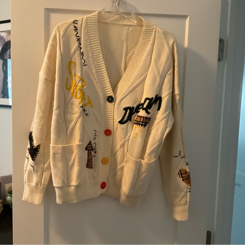 Cardigan Dream sweater. It has a cable knit look and high school sweater look.